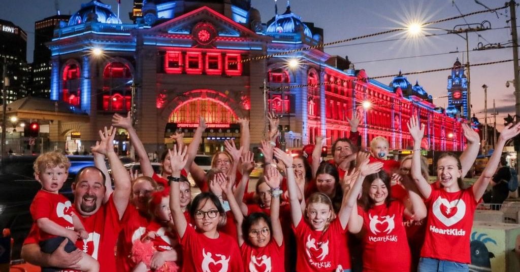 Image of four people in red HeartKids volunteer t-shirts.